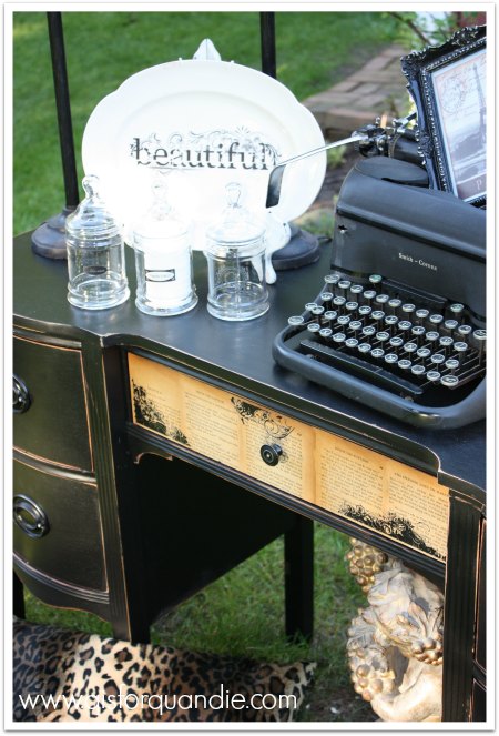 Black desk with decoupaged book pages